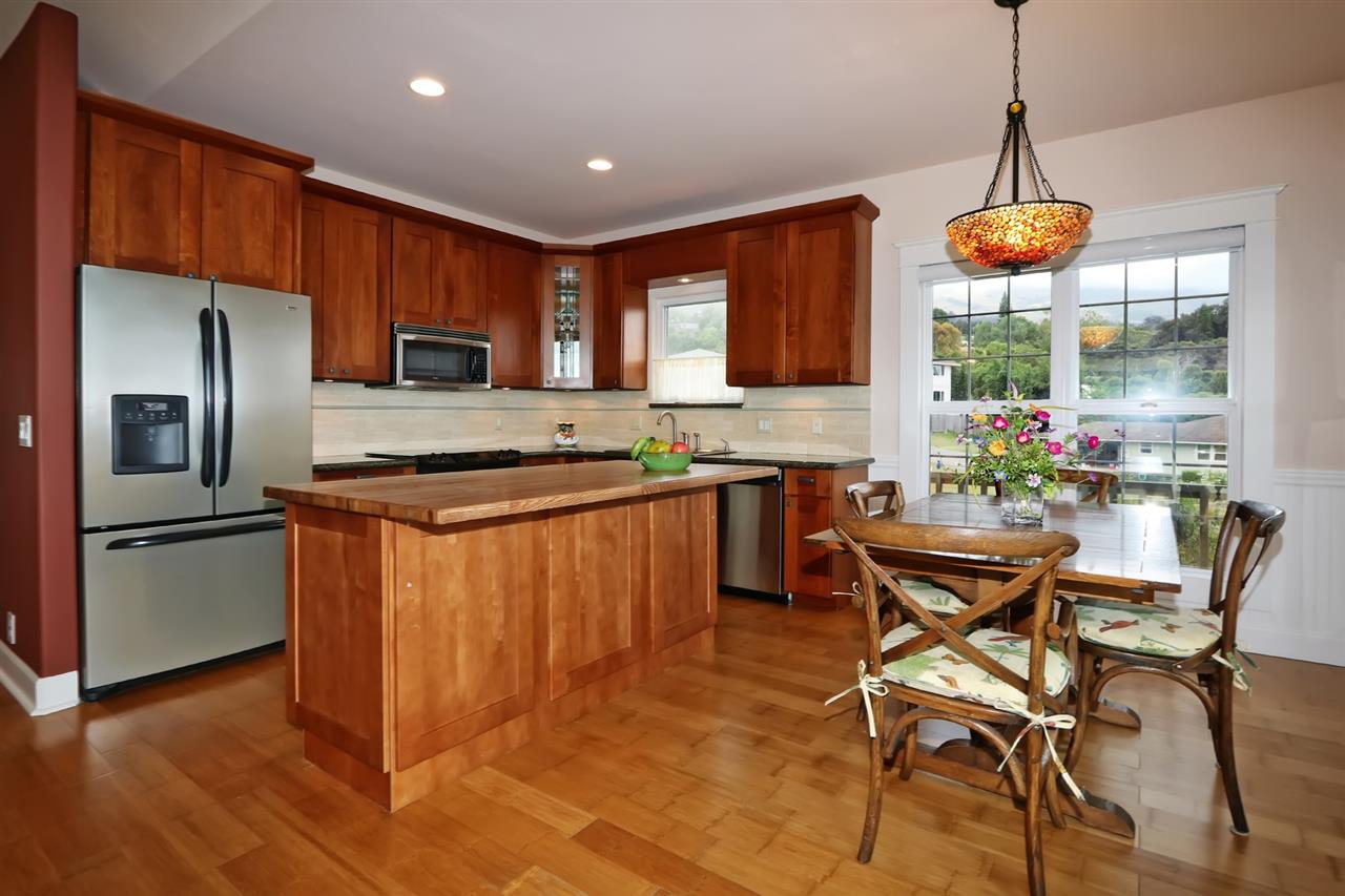 1268 Lower Kimo Drive Kula, HI 96790 - Photo 5 of 30 a kitchen with stainless steel appliances granite countertop a refrigerator a sink dishwasher a stove and a refrigerator with wooden floor