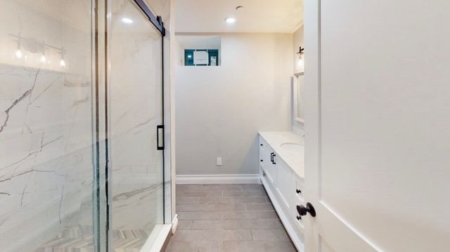 a bathroom with a double vanity sink and a mirror