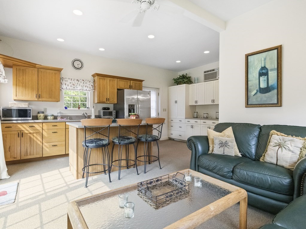 20 Jackson Road Sherborn, MA 01770 - Photo 27 of 29 a living room with furniture kitchen view and a dining table