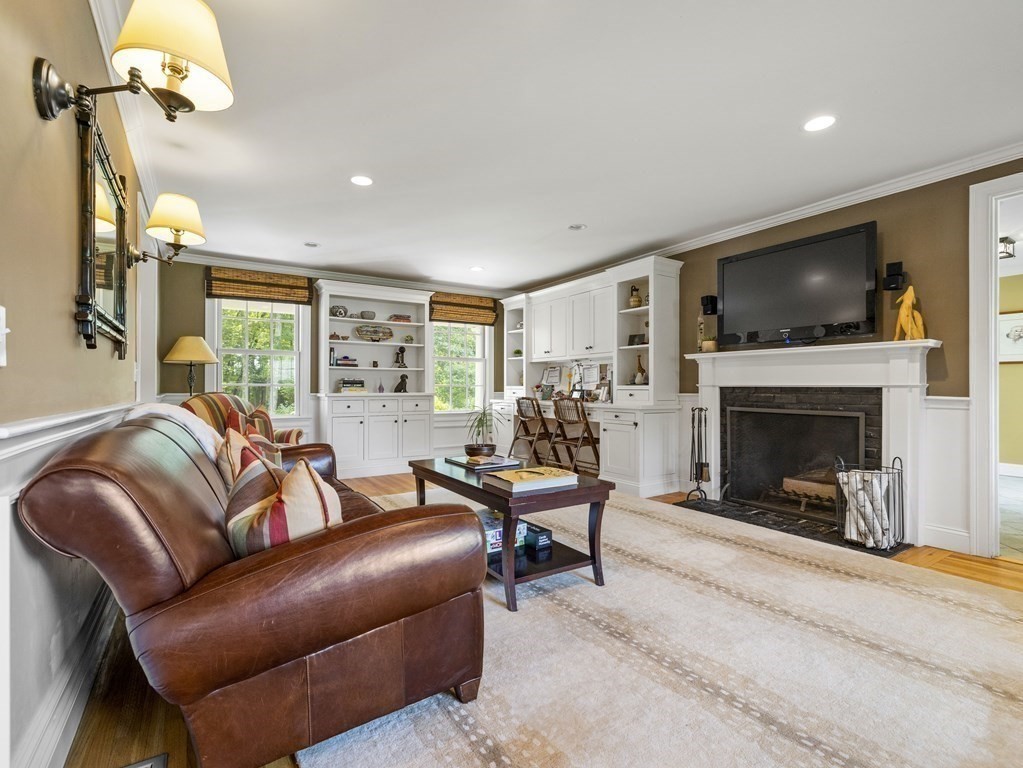 20 Jackson Road Sherborn, MA 01770 - Photo 9 of 29 a living room with furniture flat screen tv and a fireplace