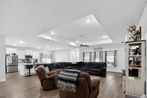 a living room with furniture and kitchen view