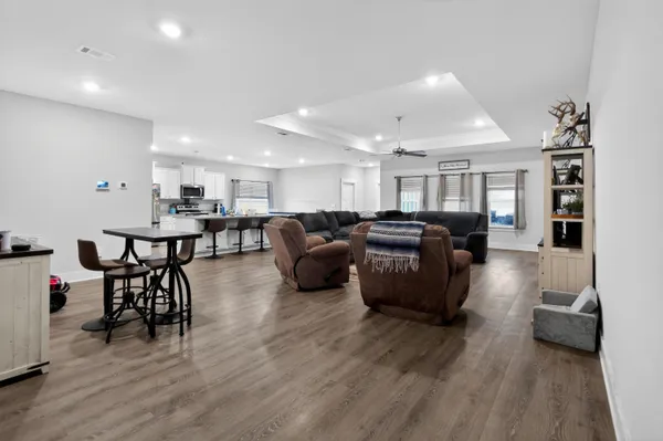 a living room with furniture and wooden floor