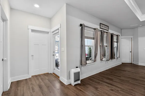 a view of a room with wooden floor and windows