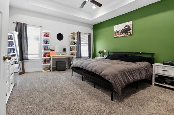 a bedroom with a bed and a painting on the wall