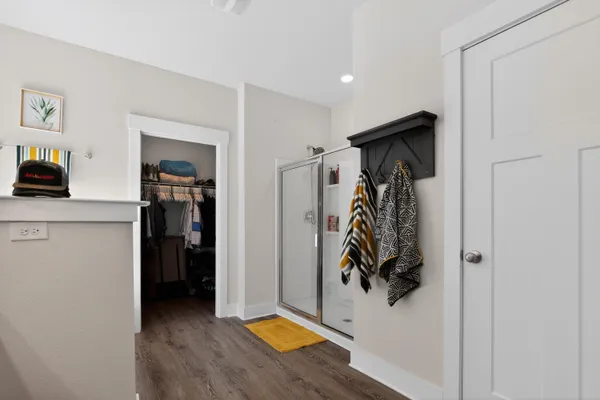 a view of walk in closet with clothes and shoes