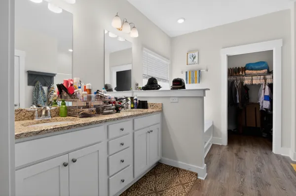 a kitchen with white cabinets and sink