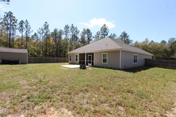 a front view of a house with a garden and yard