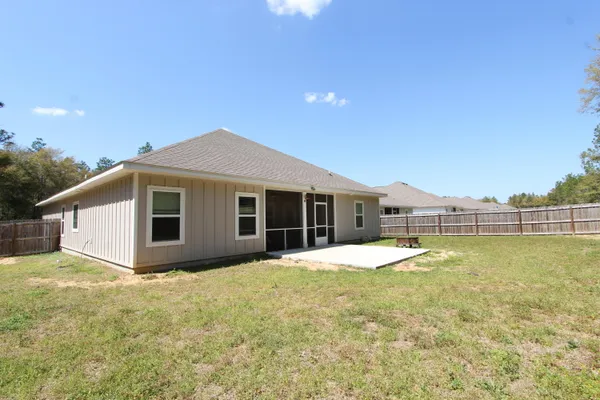 a view of a house with pool and yard