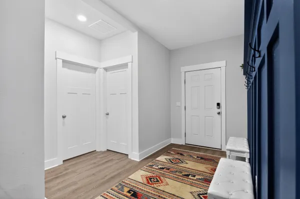 a view of a hallway with wooden floor