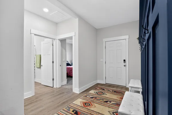 a view of a hallway with wooden floor