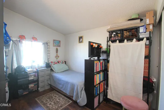 a bedroom with furniture a rug and a window