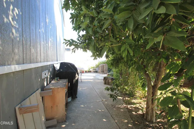 a backyard of a house with table and chairs
