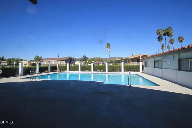 a view of a house with a backyard space