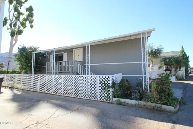 a front view of a house with wooden fence