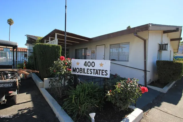 a view of a balcony with couches and potted plants