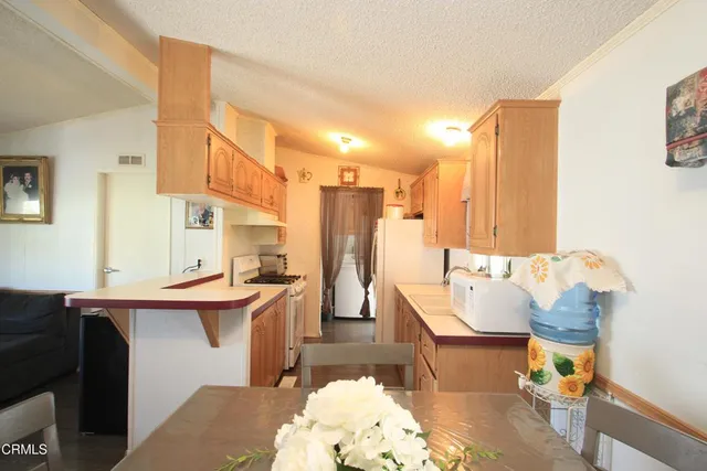 a living room with furniture a rug and a chandelier
