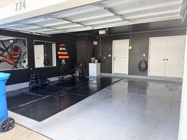 774 West 480 South American Fork, UT 84003 - Photo 72 of 76 Garage featuring an epoxy coated floor, a built-in storage cabinet, and a white paneled entry door