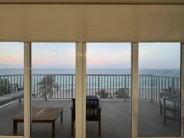 a view of a balcony with furniture