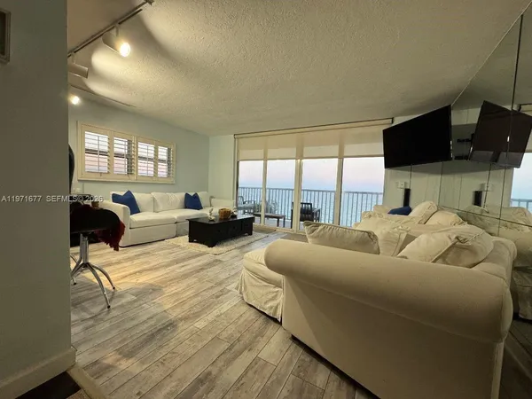 a living room with furniture fireplace and a flat screen tv