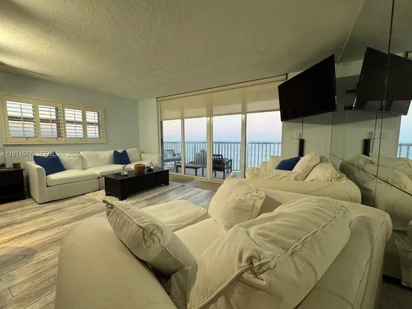 a large bedroom with a bed and glass window