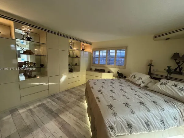 a bed room with a bed and a large window