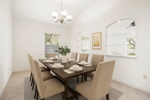 a view of a dining room with furniture and chandelier
