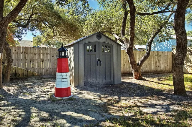 a front view of a house with a yard and tree