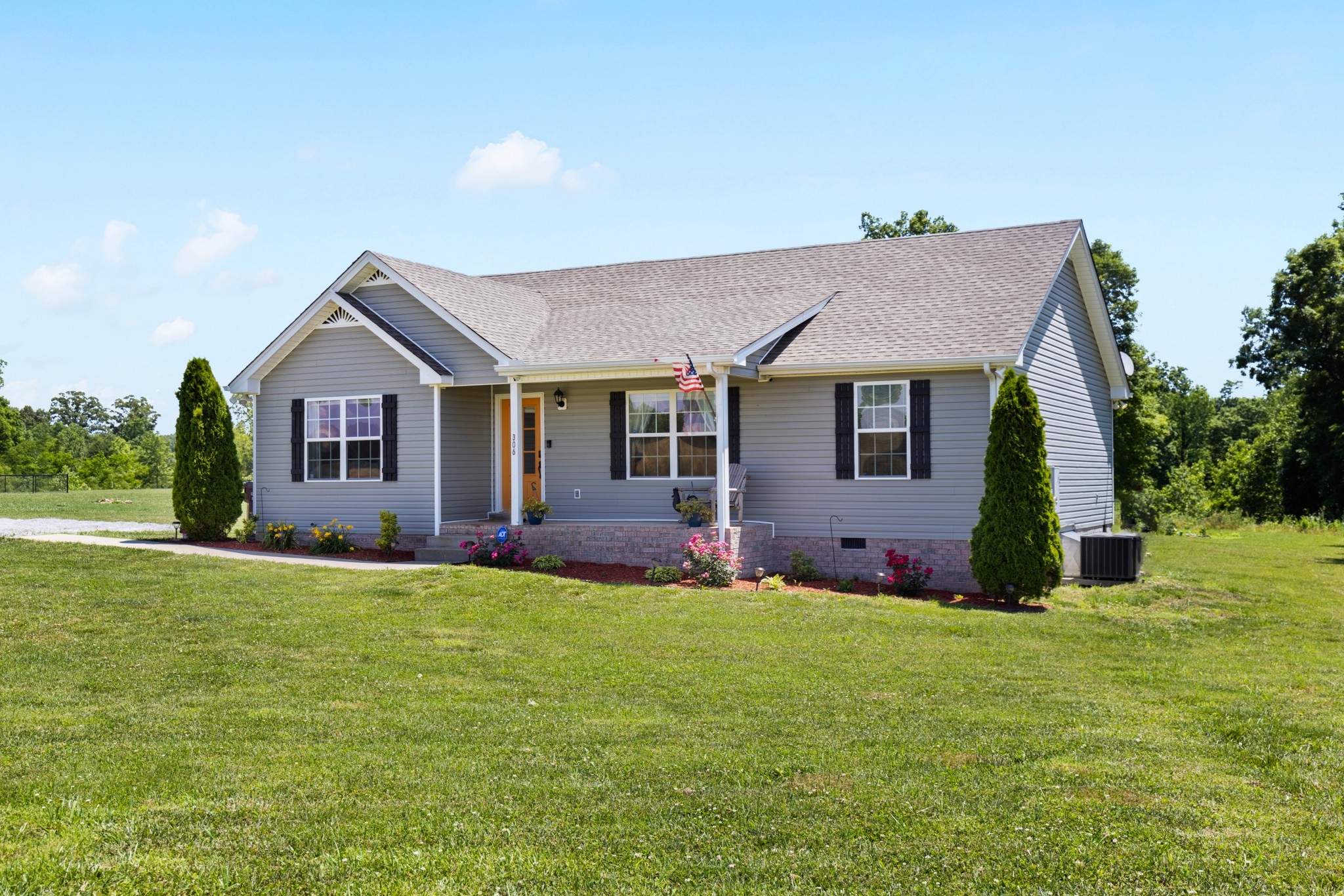 306 Meadows Road Portland, TN 37148 - Photo 2 of 31 a front view of a house with a yard and garage