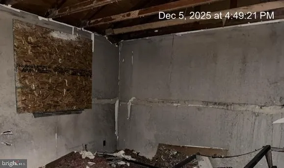 a bathroom with a walk in closet and wooden floor