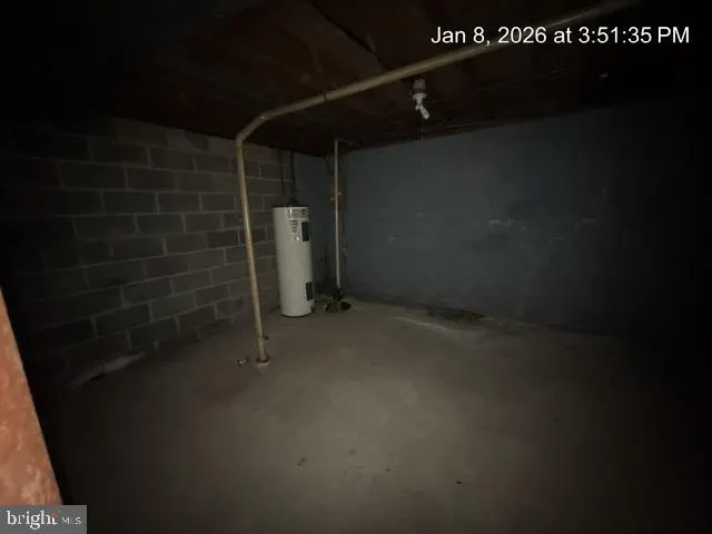 a bathroom with a walk in closet and wooden floor