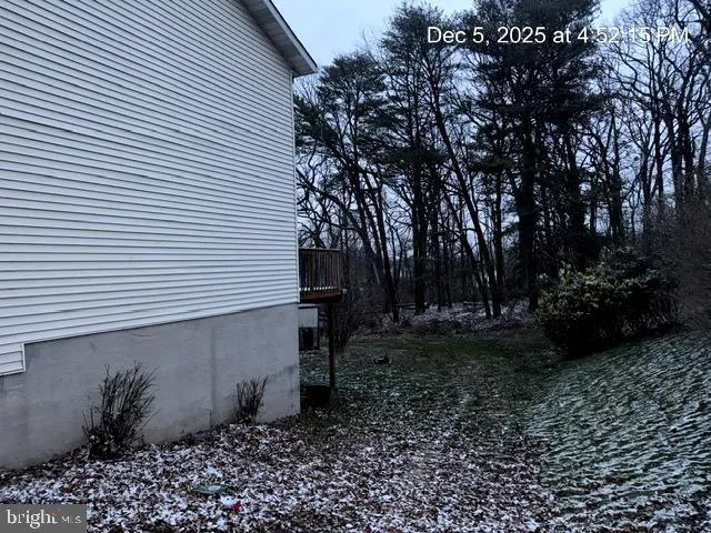a backyard of a house with lots of plants and trees