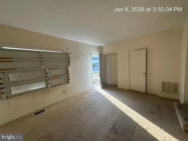 a view of an empty room with a cabinet