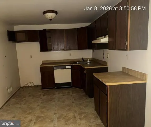 a kitchen with a sink and a stove