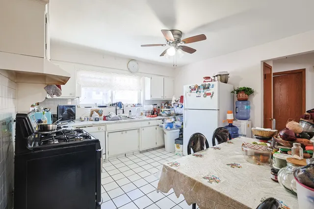 a dining hall with stainless steel appliances granite countertop a refrigerator and a stove top oven