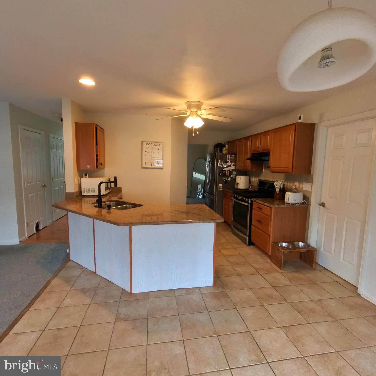 20 Mellowbrook Drive Reading, PA 19608 - Photo 14 of 39 a living room with stainless steel appliances kitchen island granite countertop a sink and cabinets