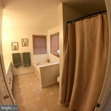 a bed room with furniture and a mirror