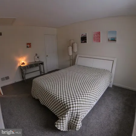 a bedroom with a bed and a mirror
