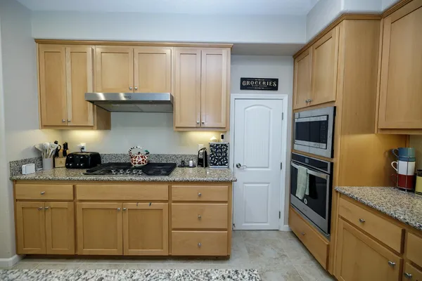 a large kitchen with a table and chairs