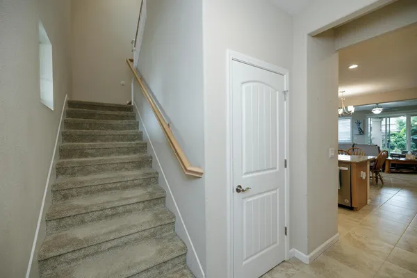 a bedroom with a large bed and ceiling fan