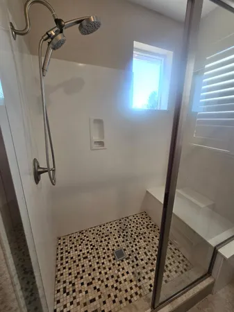 a white toilet sitting next to a bathroom sink and vanity