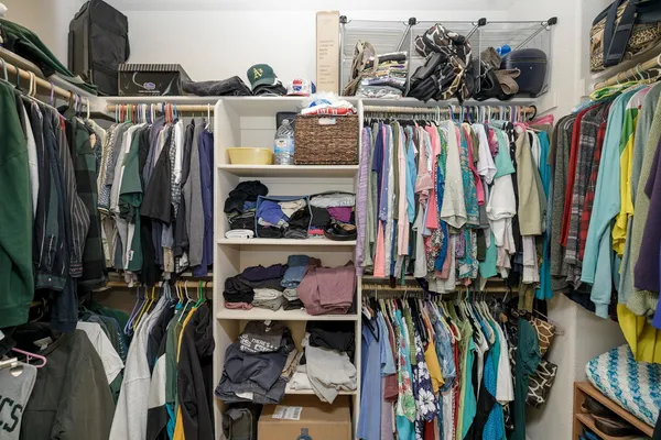 a bedroom with a bed and a flat tv screen on the dresser