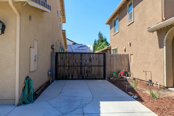 a view of a house with wooden fence