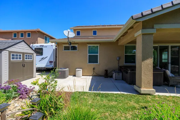 a view of a house with a yard and garden