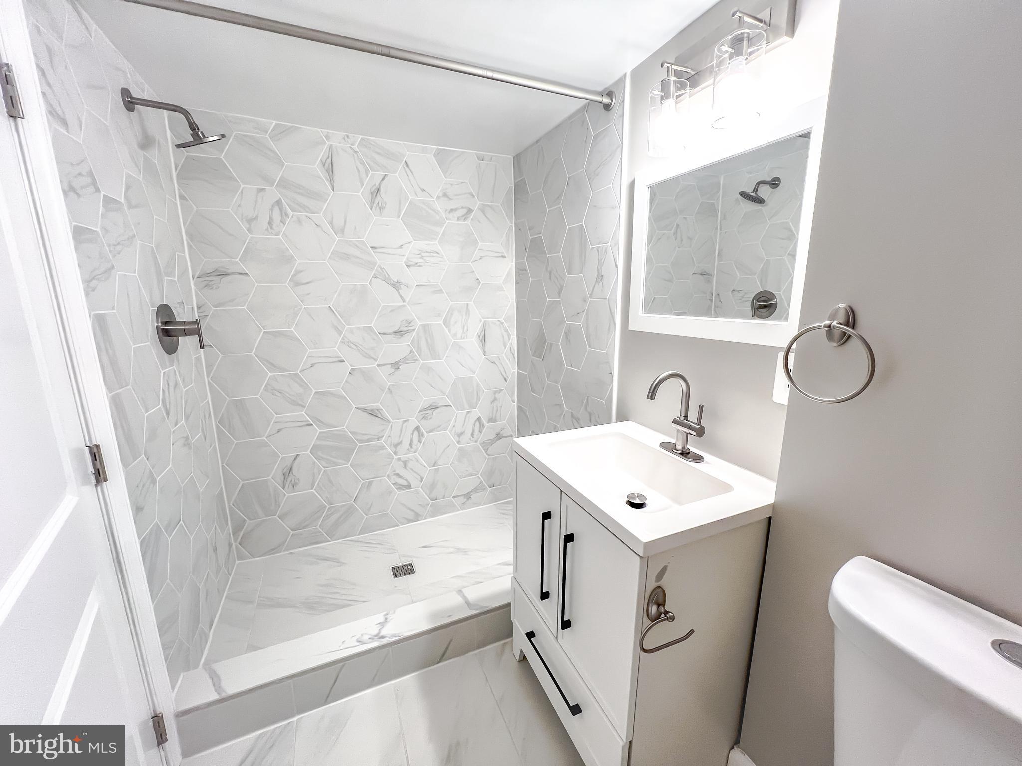 3204 Sequoia Avenue Baltimore, MD 21215 - Photo 1 of 19 a bathroom with a sink a toilet and shower