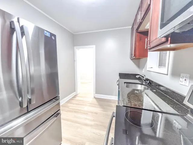 a kitchen with a refrigerator and a sink