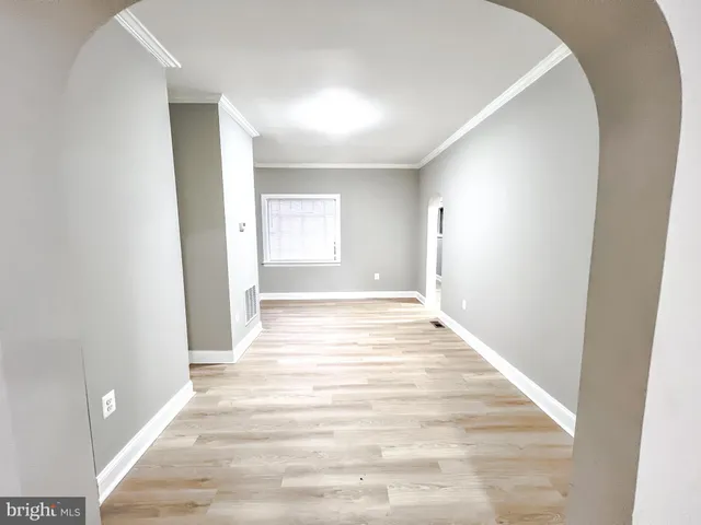 a view of an empty room and wooden floor