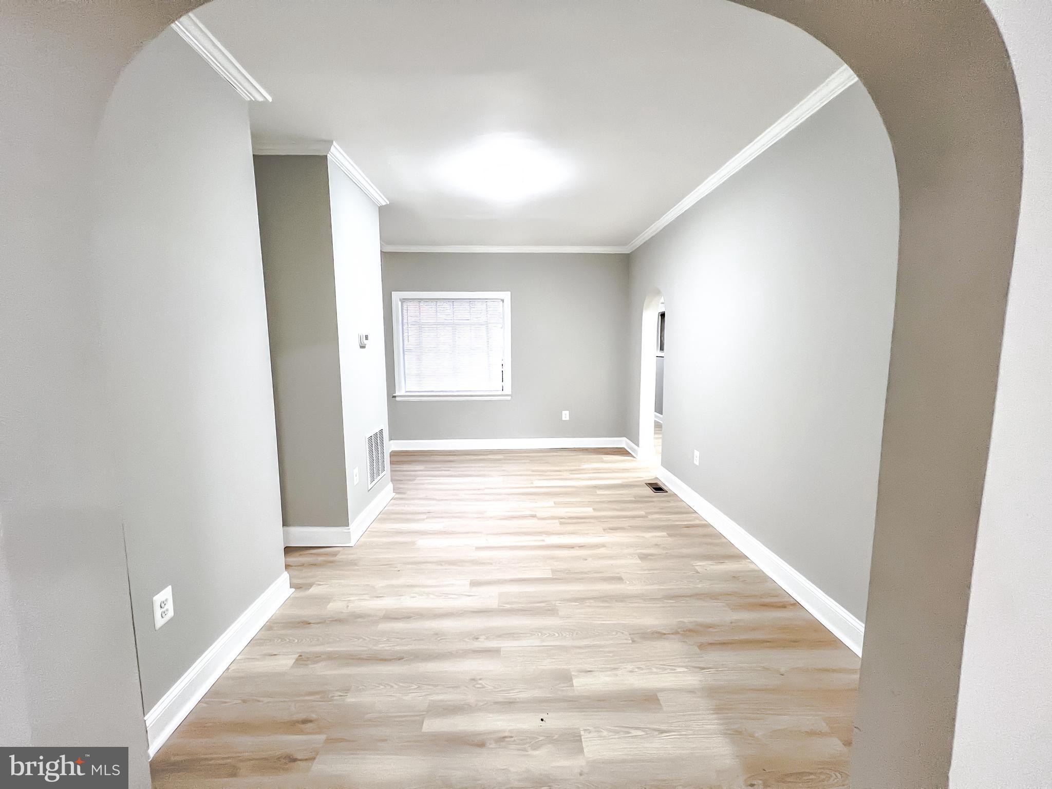 3204 Sequoia Avenue Baltimore, MD 21215 - Photo 18 of 19 a view of an empty room and wooden floor