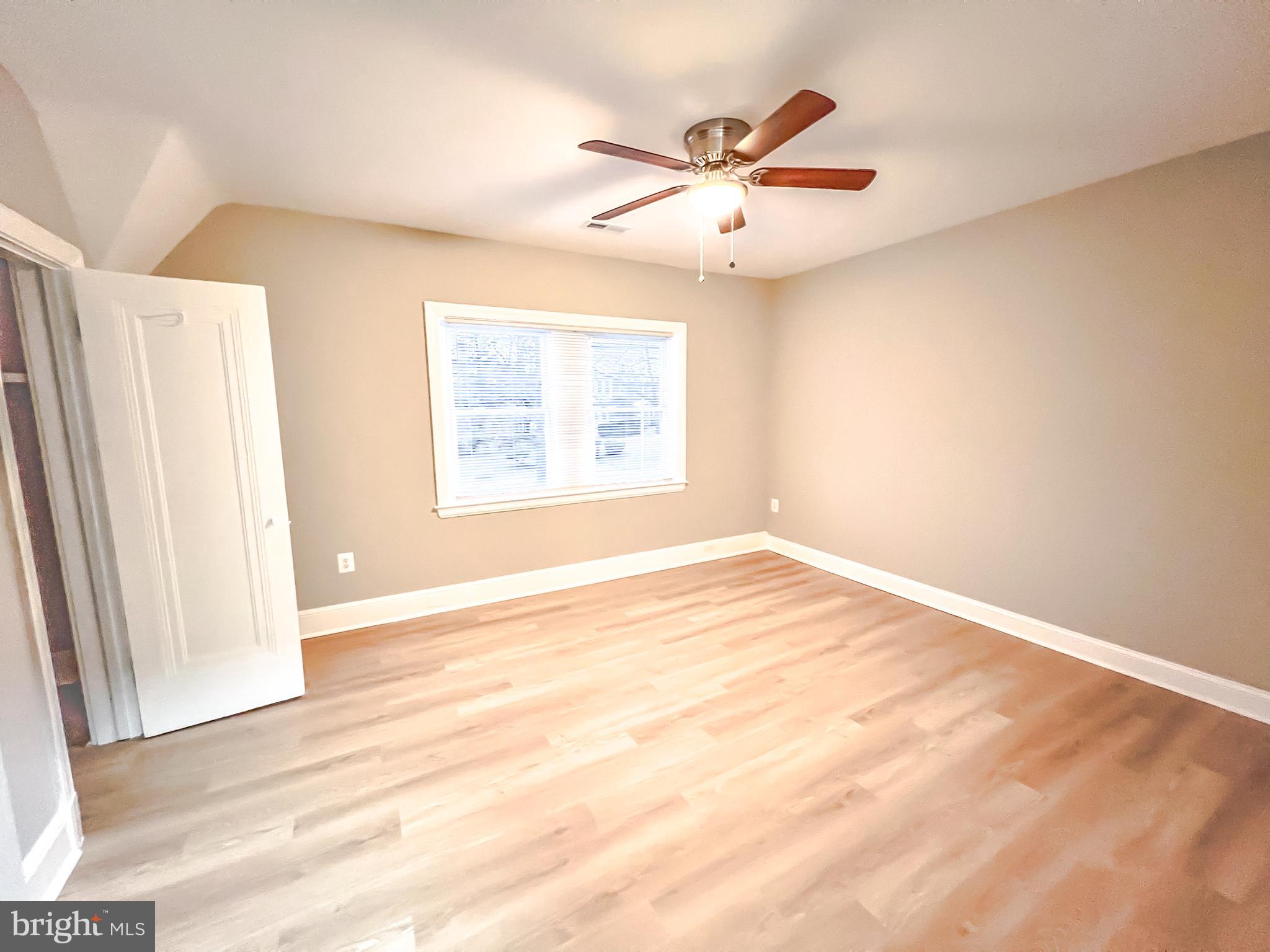 3204 Sequoia Avenue Baltimore, MD 21215 - Photo 4 of 19 a view of an empty room with wooden floor and a window