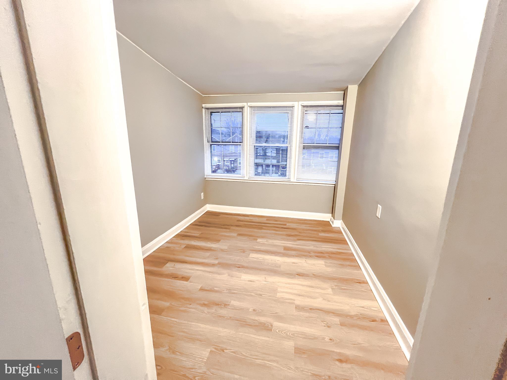 3204 Sequoia Avenue Baltimore, MD 21215 - Photo 6 of 19 a view of empty room with wooden floor and fan