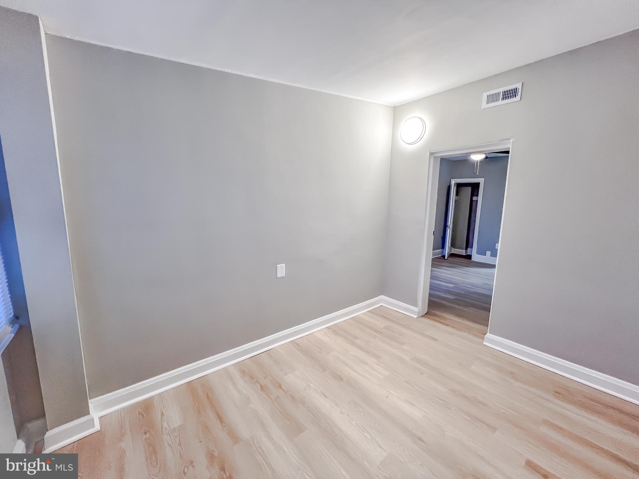 3204 Sequoia Avenue Baltimore, MD 21215 - Photo 9 of 19 a view of an empty room with wooden floor